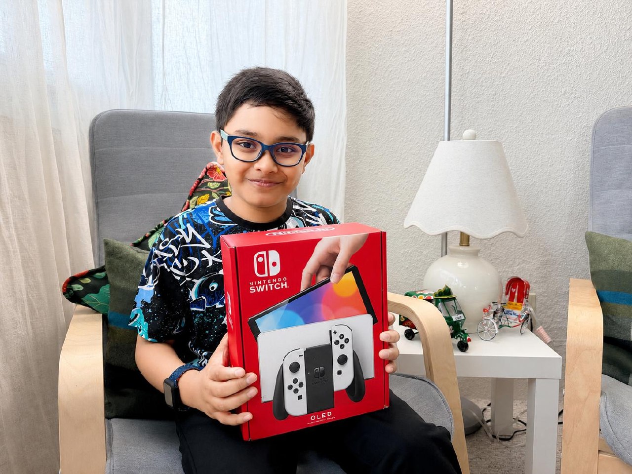 2026 Brush-a-mania Nintendo Switch grand prize winner Shabaz Zarif of Seneca Hill Public School holding his new console